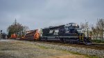 NS 3416 is pulling a section of track by the AMTRAK station